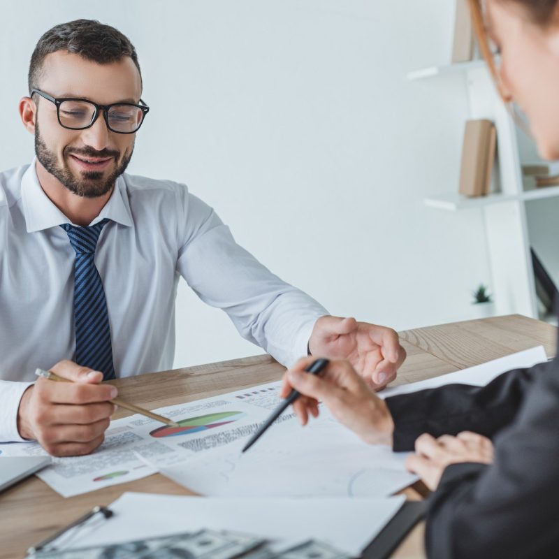 cheerful-financiers-pointing-on-documents-in-office.jpg